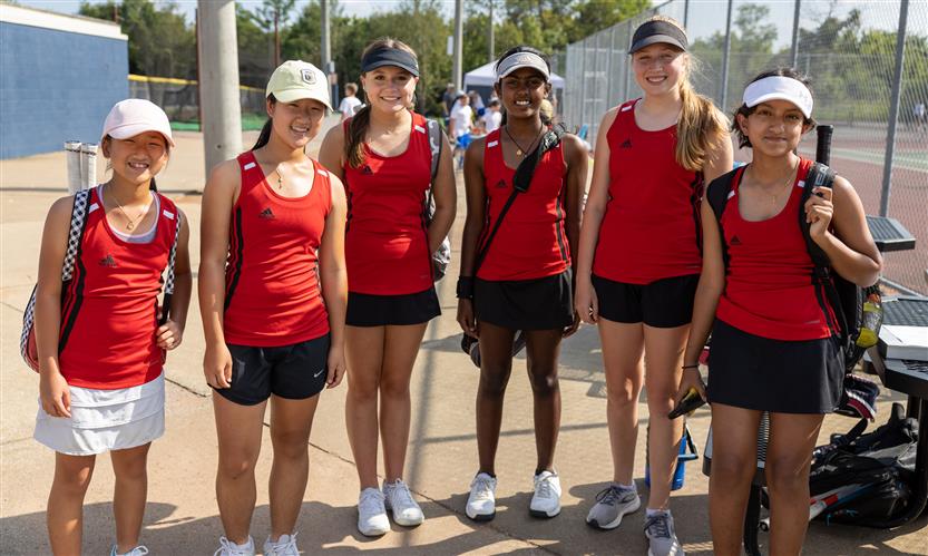 A group of tennis players stand together